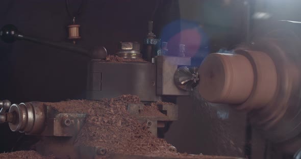 Artist creating a buddhist prayer wheel on a lathe alt