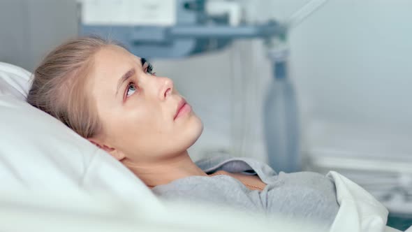 Young Female Patient Lying in a Hospital Room alt