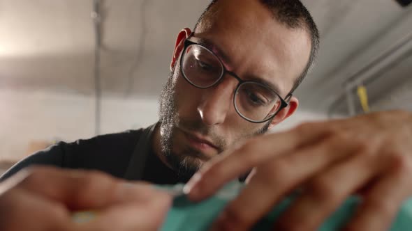 Close-up: a man works with a blade. Production of decorative elements. Workshop. alt