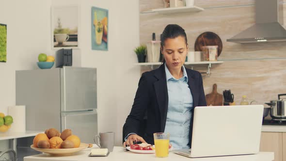 Business Woman Eating Toasted Bread alt