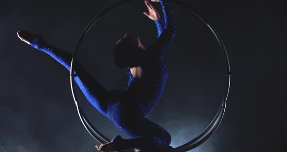 Graceful Woman is Doing Aerial Gymnastics in the Hoop Spinning alt