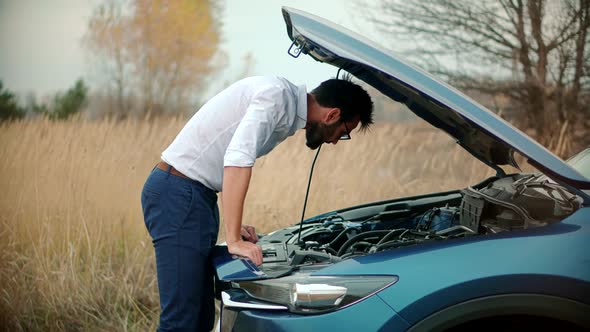 Businessman Repairing Accident Car. Man On Broken Car. Vehicle Check Engine Damage Troubles. alt
