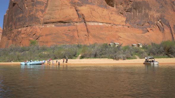 People and boats at the river bank alt