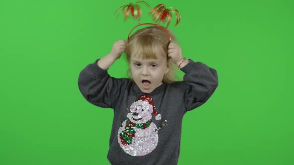 Happy Beautiful Little Girl in a Sweater with a Snowman. Christmas. Chroma Key alt