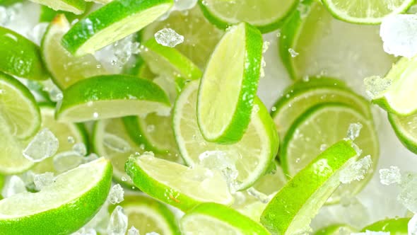 Super Slow Motion Shot of Flying Fresh Lime Slices and Crushed Ice Towards Camera at 1000Fps alt
