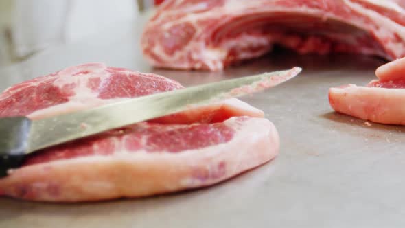 Close-up of knife on sliced red meat alt