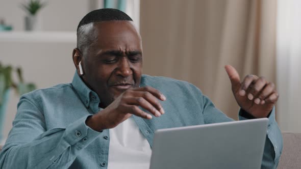 African American Businessman Freelancer Distracted From Work By Laptop Happy Man Sitting Home on alt