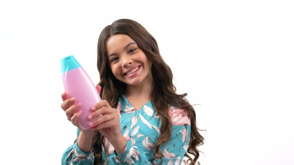 Happy Teen Girl Turning Showing Her Long Curly Hair Presenting Shampoo Show Thumb Up Daily Habits alt