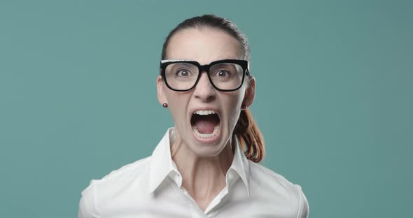 Aggressive angry woman shouting at camera