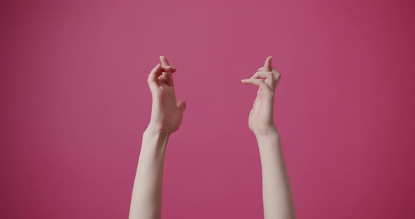 Filming Only Hands That Hope and prayConcentrated Isolated on a Pink Background alt