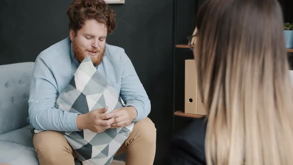 Troubled Guy Crying and Sharing Problems During Appointment with Professional Psychologist alt