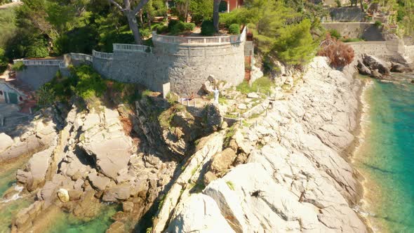 Fly Around a White Jesus Statue on the Rocky Hill in Ligurian Sea alt