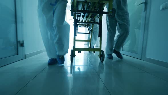 Medical Trolley Is Getting Moved By a Group of Paramedics alt