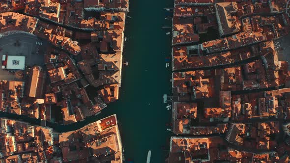 Top down dolly forward drone shot over the Grand canal Venice and Ponte Di Rialto bridge alt