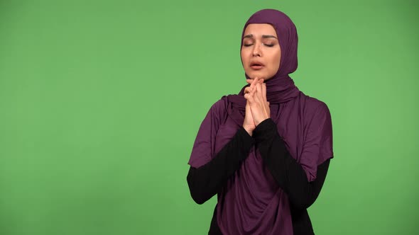 A Young Beautiful Muslim Woman is Sad and Cries  Green Screen Background