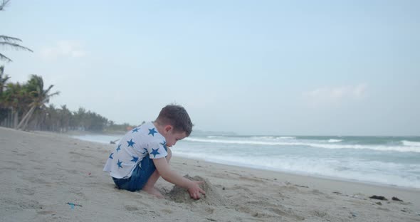 Carefree Baby Boy Builds a House From Sand Child Plays By the Sea alt