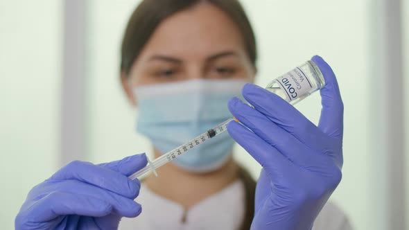 Closeup A Vial of the COVID19 Coronavirus Vaccine is Being Used By a Scientist alt