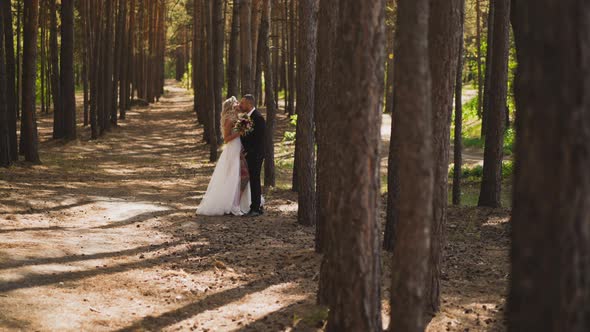 Lady Bride in Wedding Dress with Venthole Kisses Husband alt