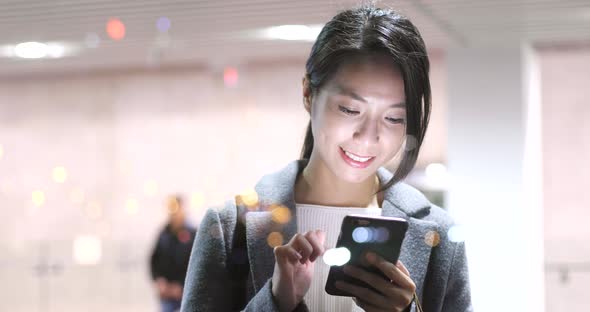 Woman Use of Mobile Phone in City at Night alt