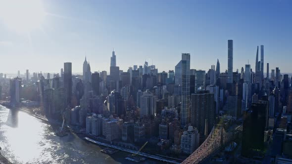 East River Amidst Buildings in City Drone Flying Backward From Skyline alt