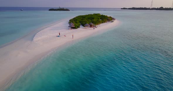 Paradise tiny tropical island with beautiful white sandy beach and turquoise calm lagoon visited by alt