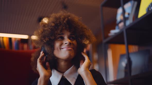 Young Woman Laughing And Listening To Music Through Headphones alt