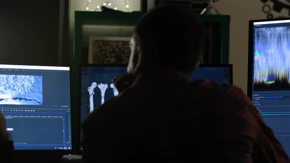 Man Editing Video on Computer alt