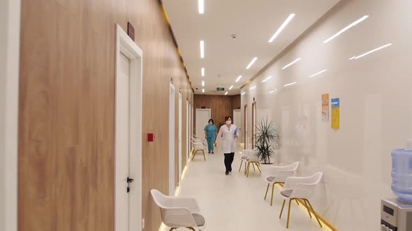 Doctors Walk Down The Hospital Corridor