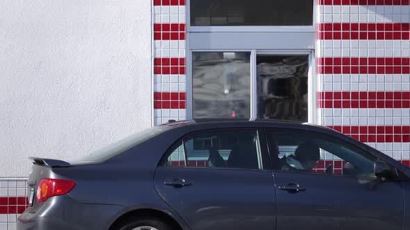 Car Driving Through a Fast Food Drive Thru alt