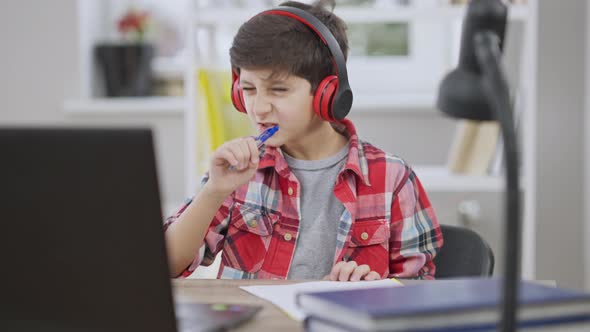 Portrait of Excited Joyful Middle Eastern Boy in Headphones Singing and Gesturing in Slow Motion alt