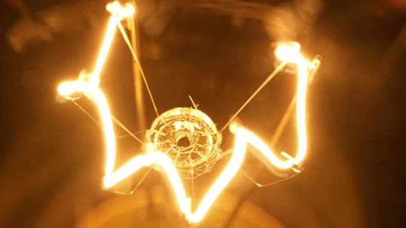 4K - Filament of a light bulb. Close-up alt