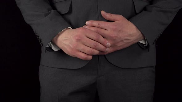 A Young Businessman in a Suit Takes Off His Wedding Ring and Puts It in His Pocket alt