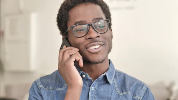 African Man Talking on Phone alt