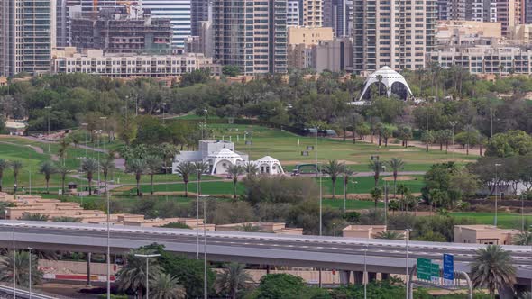 Dubai Golf Course with a Cityscape of Gereens and Tecom Districts at the Background Aerial Timelapse alt