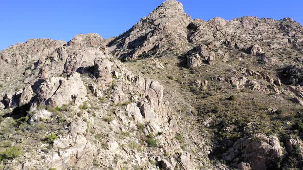 Coyote Mountains ridge and wilderness, Arizona. Slow Aerial climb showing sharp edge rocks and Sagua alt