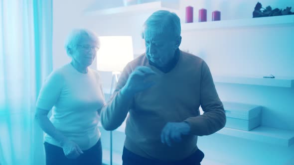 Happy Elderly Couple Dancing at Home in Formal Wear alt