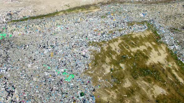 The huge garbage dump on the outskirts of the forest, view from drone alt