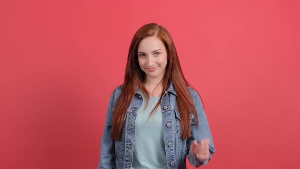 Come To Me. Young Woman Pointing at Someone To Come alt