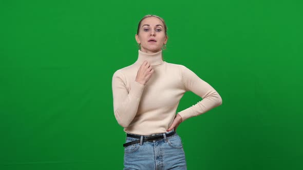 Portrait of Young Woman Feeling Hot on Green Screen alt