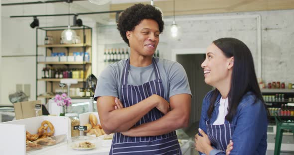 Animation of happy diverse female and male waiters at coffee shop alt