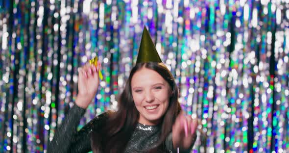 A Young Pretty Girl in a Brocade Dress and a Party Hat on Her Head Celebrates Her Birthday She alt