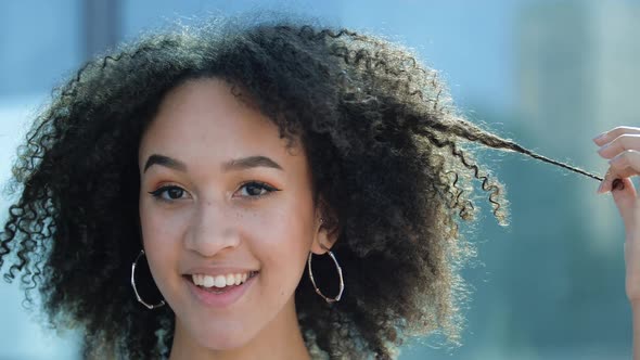 Close-up Face African American Ethnic Girl Curly Hairstyle. Young Beautiful Playful Woman Holding alt