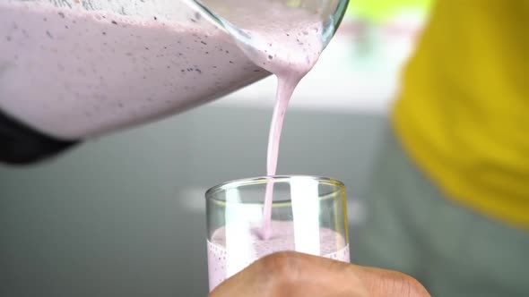 Pour Smoothie Into a Glass From a Blender