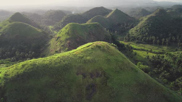 Philippines Hilly Countryside Aerial Misty Haze Over Mountain Ranges with Tropical Jungle Forest alt
