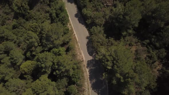 Flying above a young man skateboarding on a road