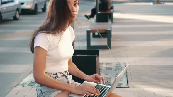 Girl Teenager Uses a Laptop alt