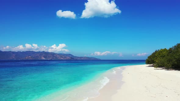 Vivid colors of fabulous seascape with blue turquoise sea washing exotic beach by white waves under alt