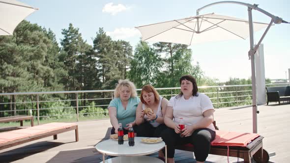 Three Fatty Women Having Fast Food Lunch alt