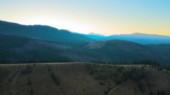 Beautiful Mountain Panoramic Landscape with Hazy Peaks and Foggy Valley at Sunset alt