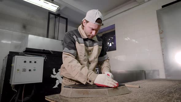 The Worker Controls the Quality of the Master Model. A Man Monitors the Correct Form alt